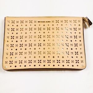 Small, pink Michael Kors clutch purse.